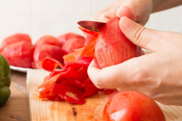 在煤气炉上烤番茄可以更快地剥皮